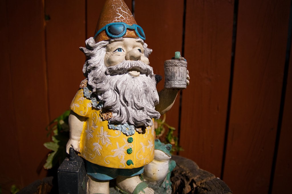 garden gnome with a cup in his hand